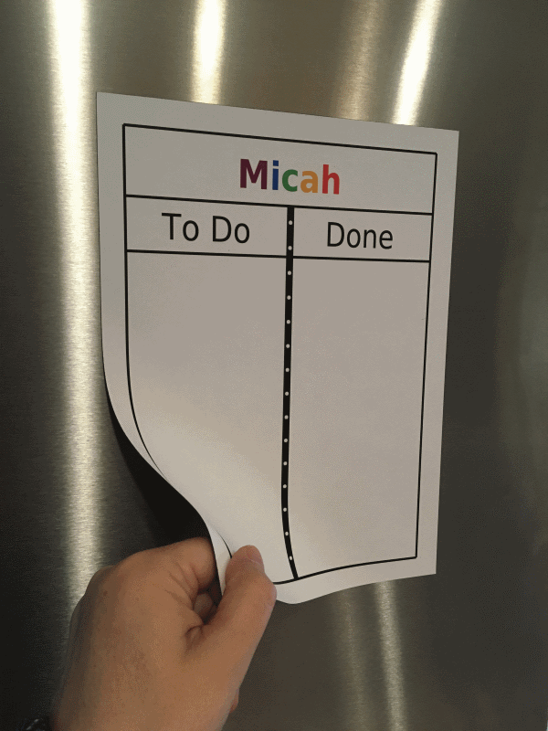 Magnetic to do / done board with hand moving a magnet over